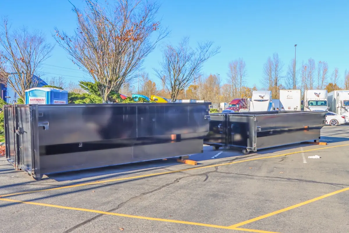 Professional dumpster rental service with roll-off container on residential driveway in Millburn